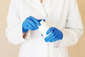 Farmacéutico con bata blanca y guantes azules Farmacia